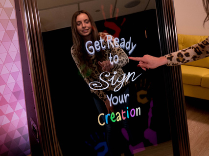Guest signing their photo on the mirror booth touchscreen